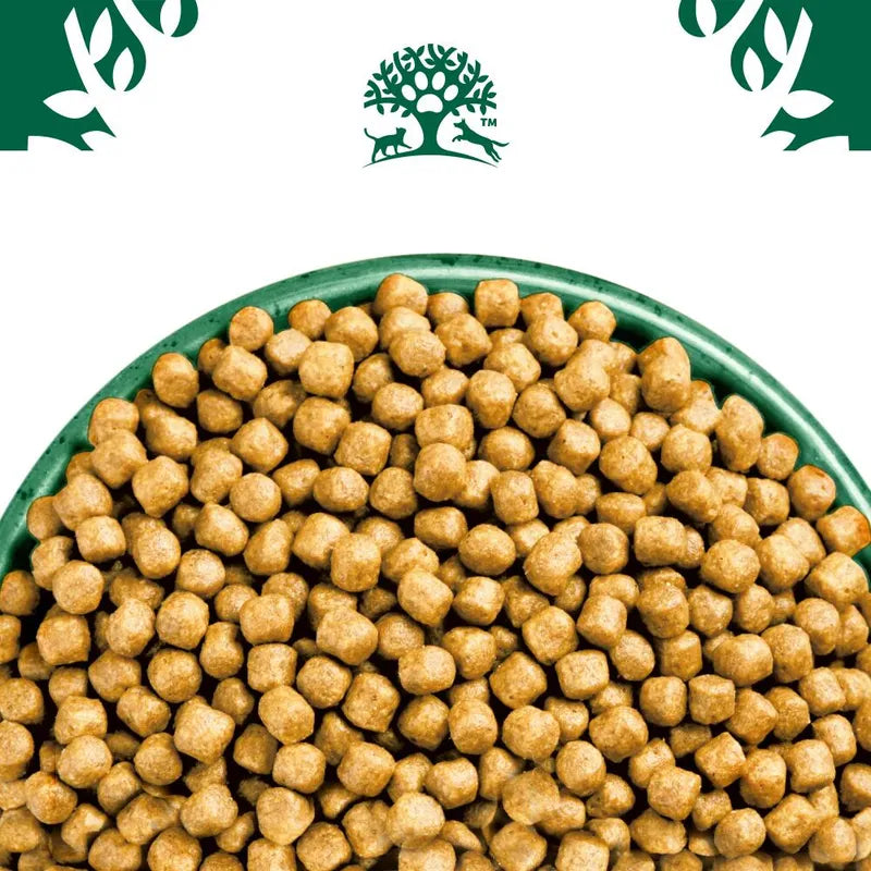 Dog food pellets in a green bowl with a brand logo on a white background